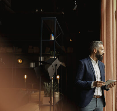 Businessman in cafe holding digital tablet